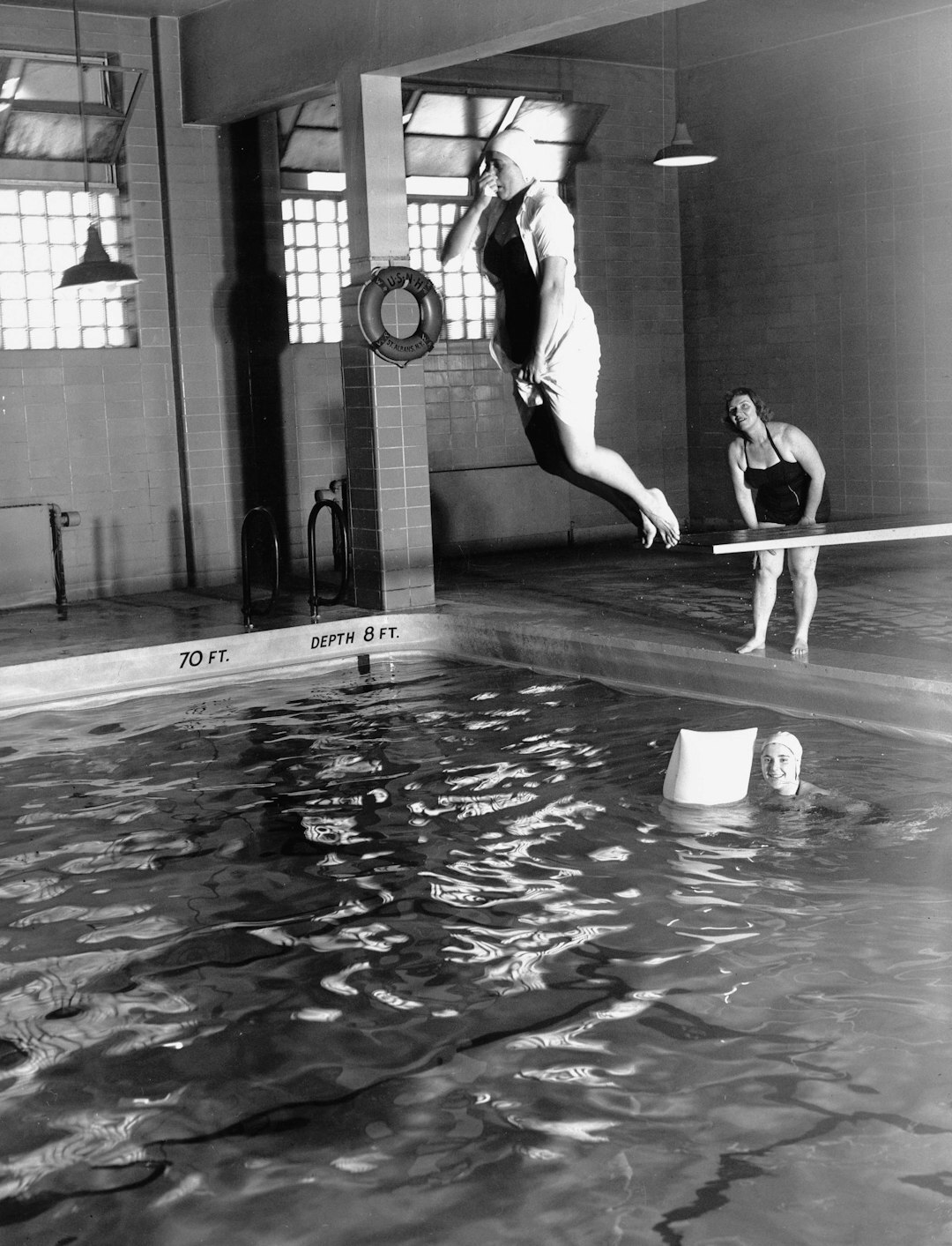 Seniors participating in a water aerobics class in an indoor pool