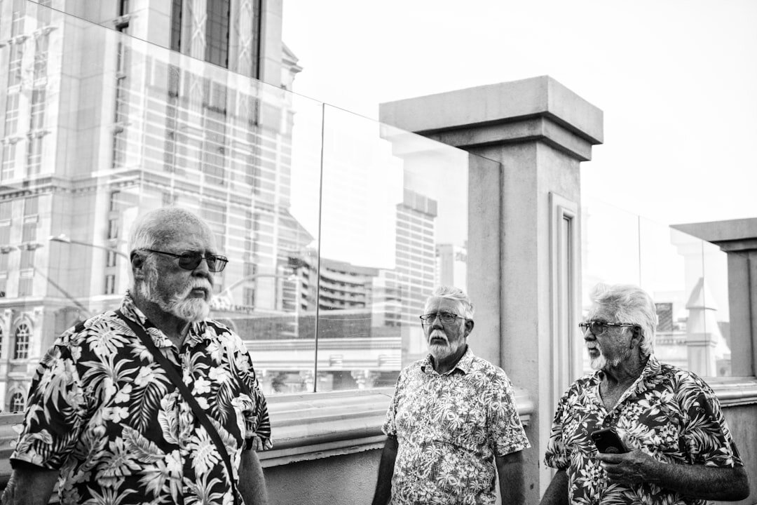 Diverse group of active seniors laughing together outdoors on a sunny day