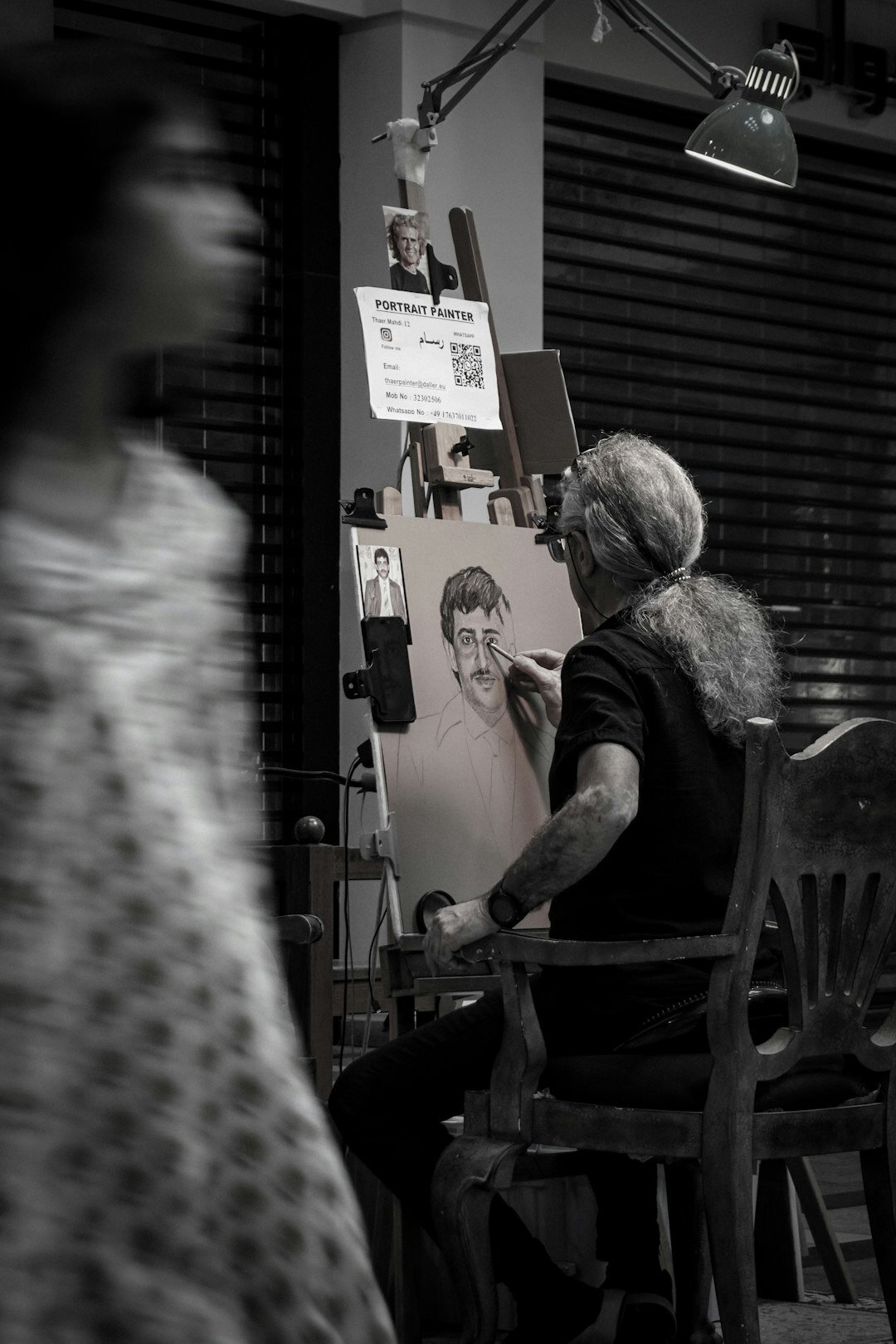 Senior woman painting on a canvas during an art class
